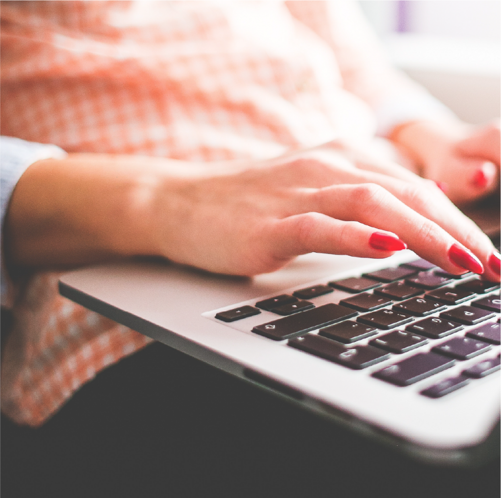 A person typing on a laptop computer.